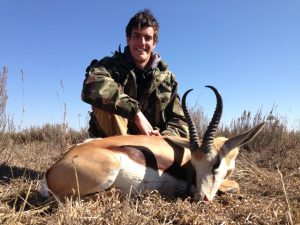 a hunter posing with the antelope he hunted with .30-30 ammo